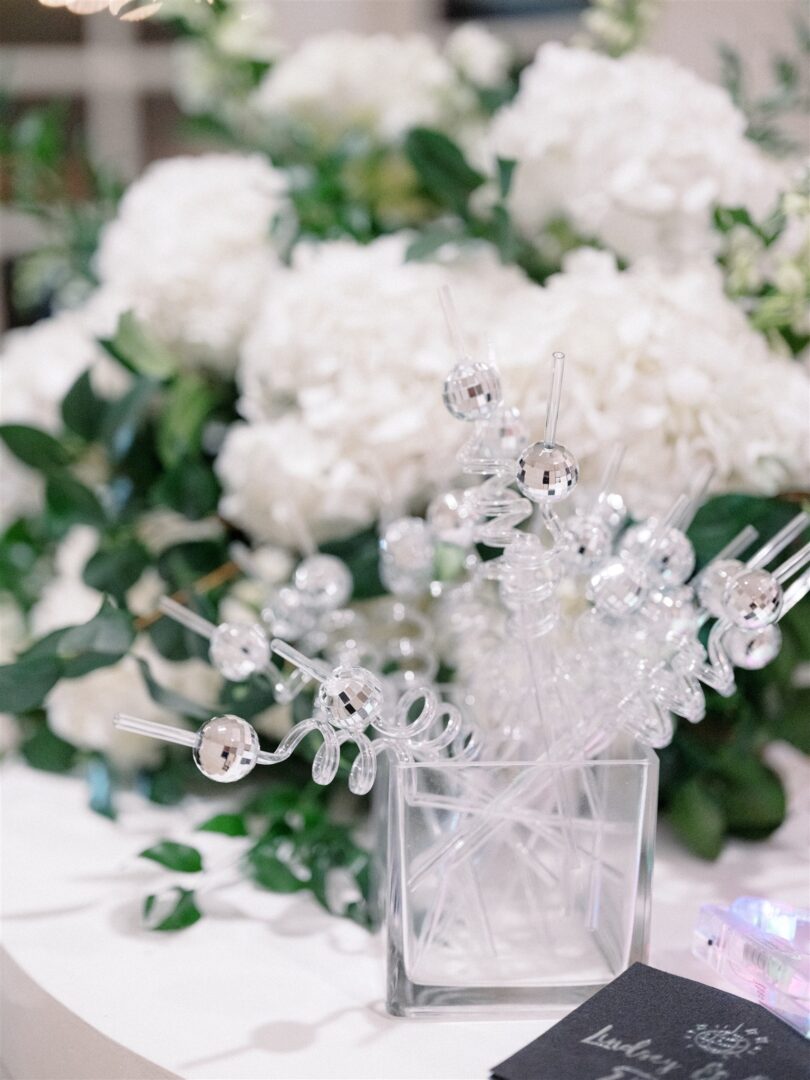 A close-up of disco ball-themed drink stir sticks for a late night wedding reception.