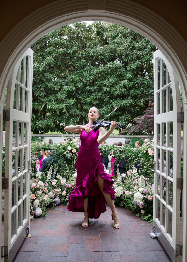 A violinist provides cocktail hour entertainment at a luxury wedding.