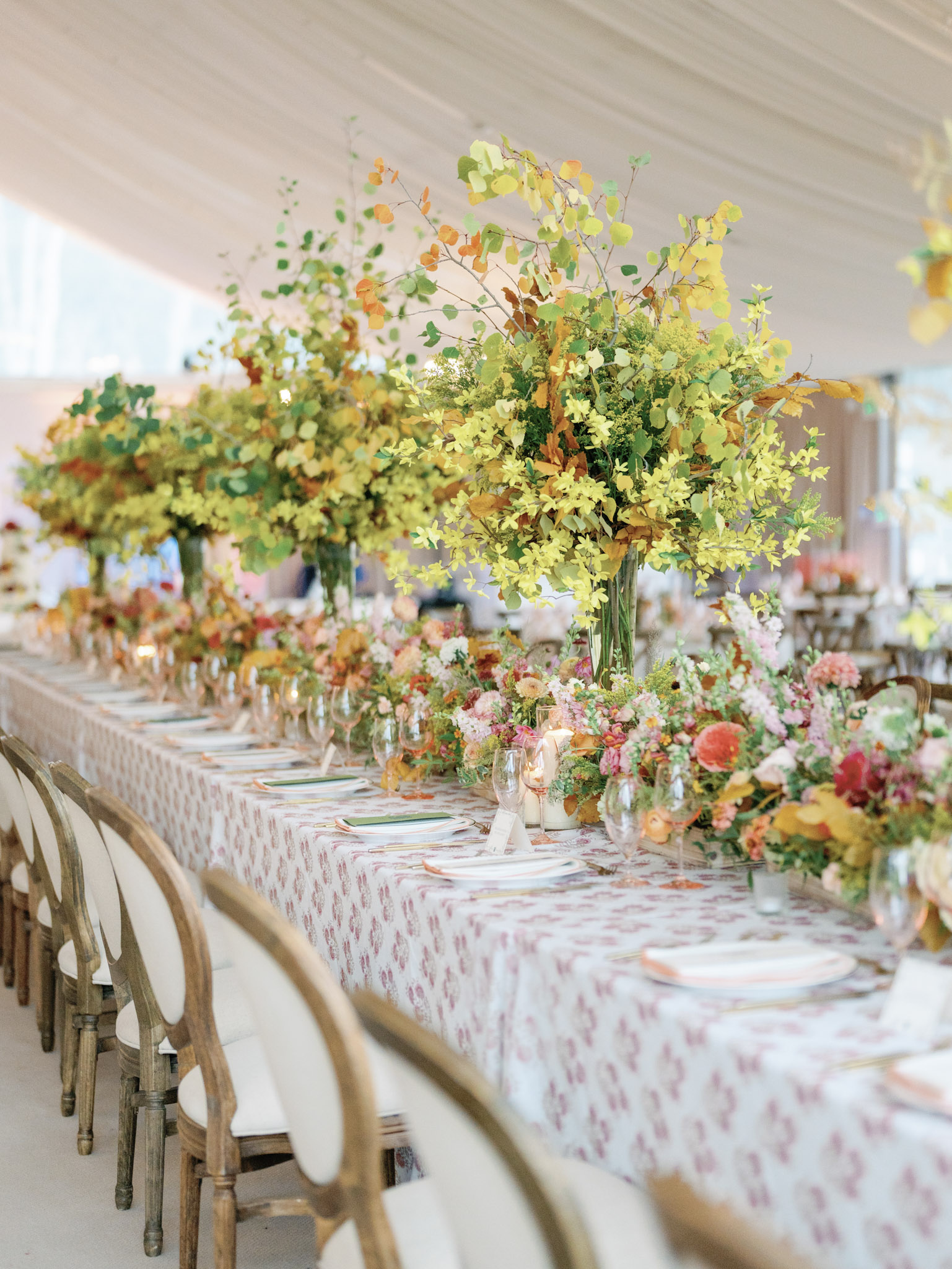 An polished mountain wedding reception design, featuring fall colors and aspen leaf centerpieces.