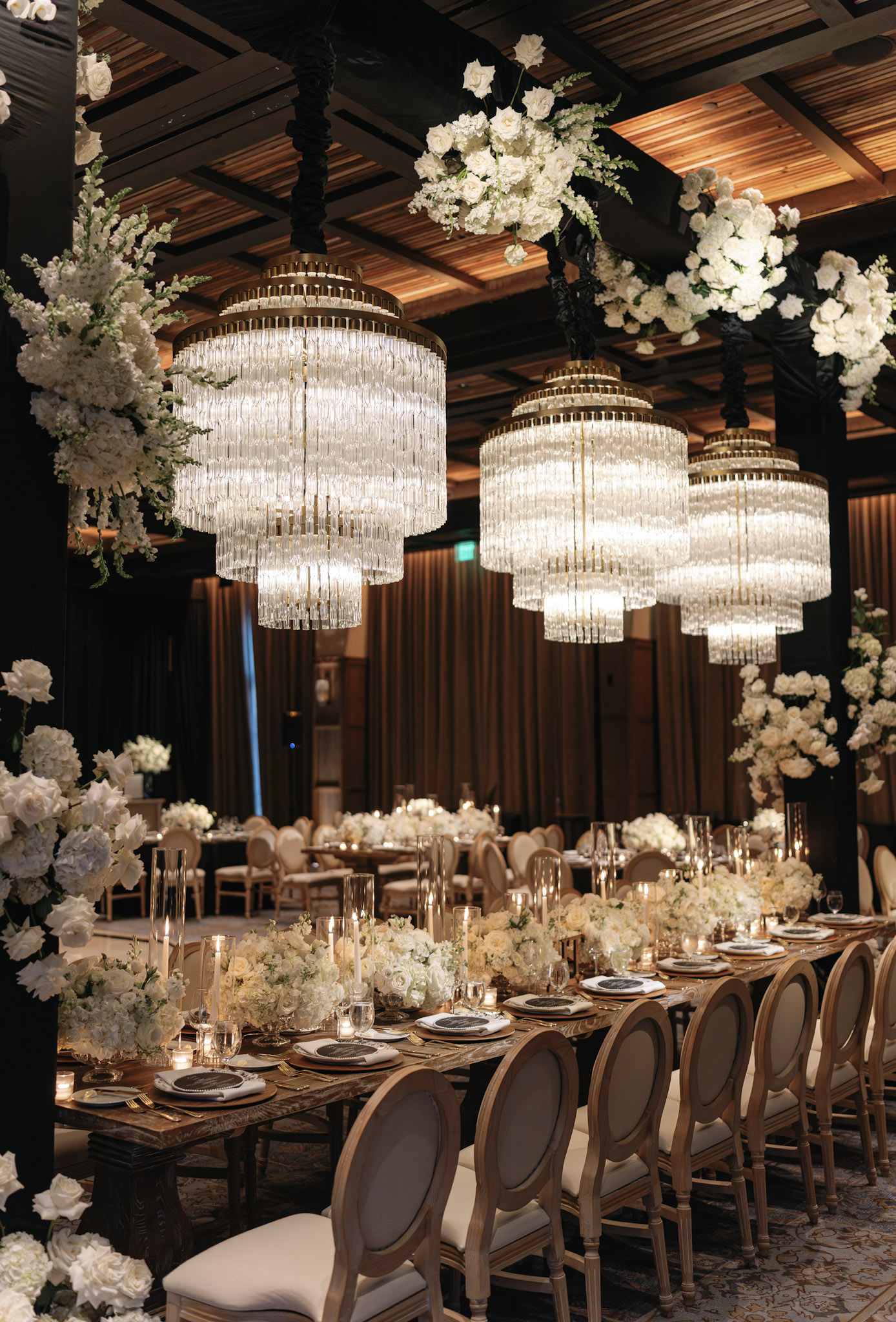 Moody lighting and modern black and white design elements create an upscale wedding reception aesthetic.