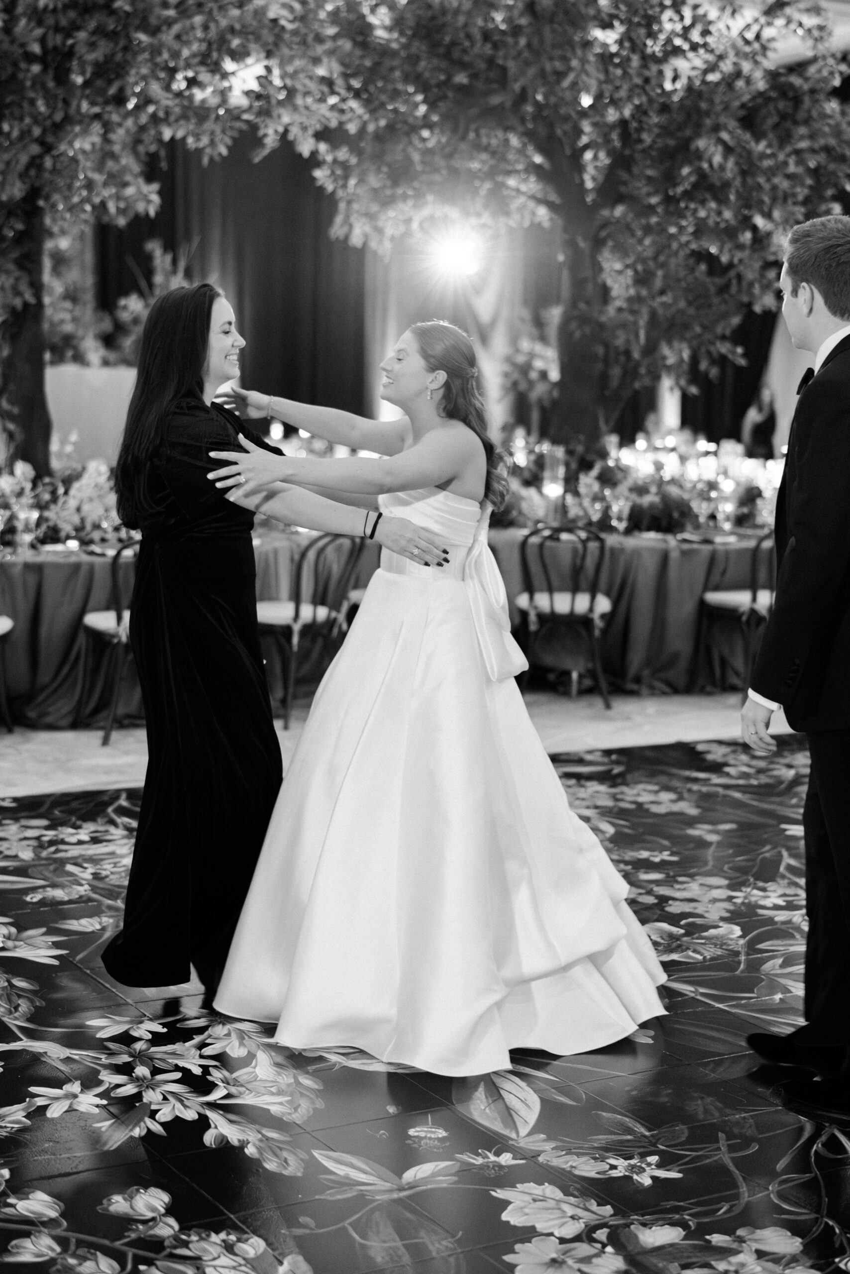 A happy bride embraces her wedding planner upon seeing her reception space.