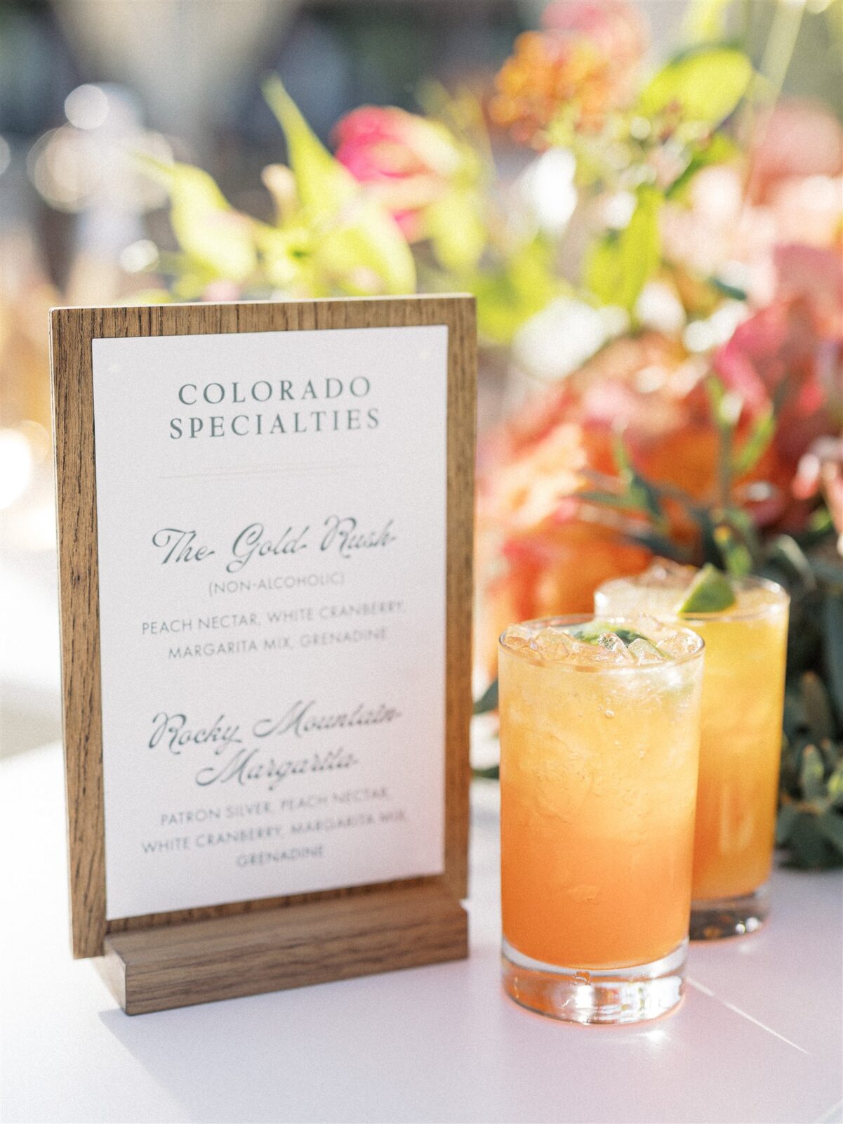 A rustic bar menu advertises seasonal cocktails for a mountain wedding.